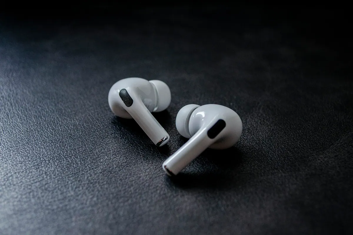 White earbuds on dark fabric